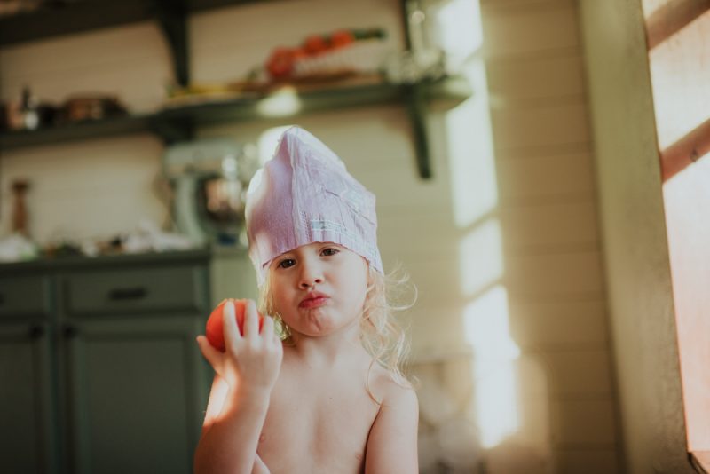 child eating vegetable