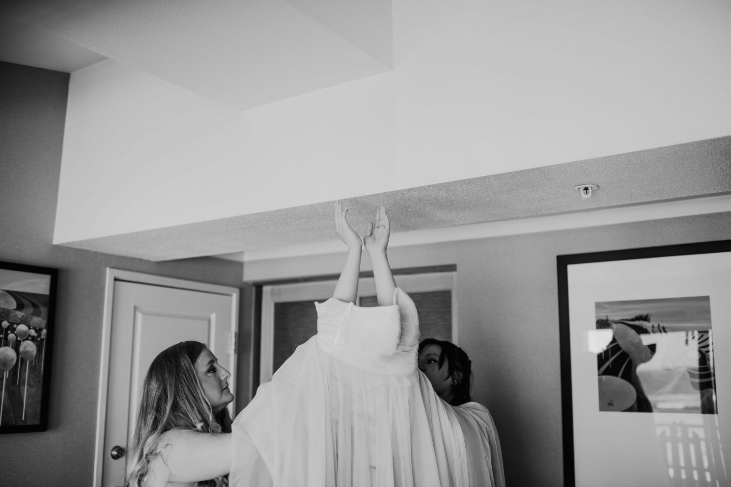 Bride putting dress on