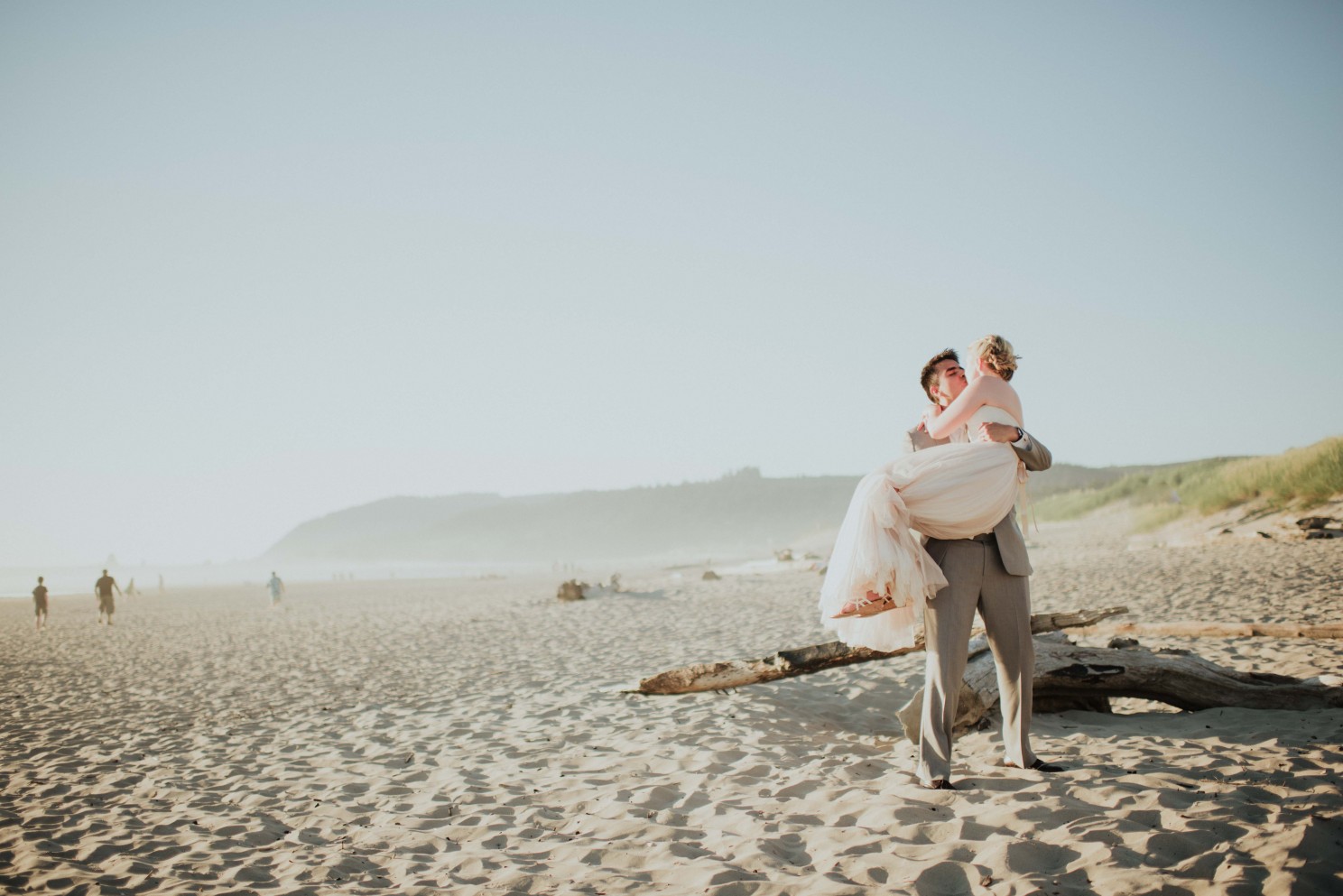 Groom with bride in his arms