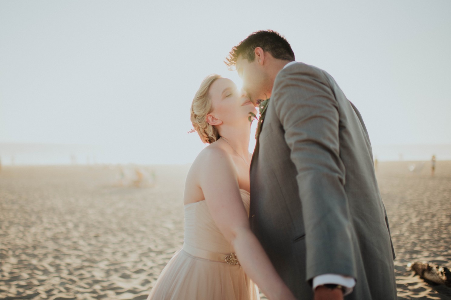 Grooms kissing bride