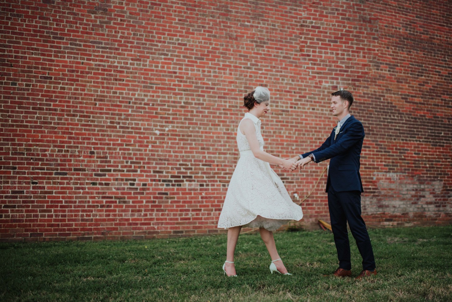 bride and groom dancing in the field 