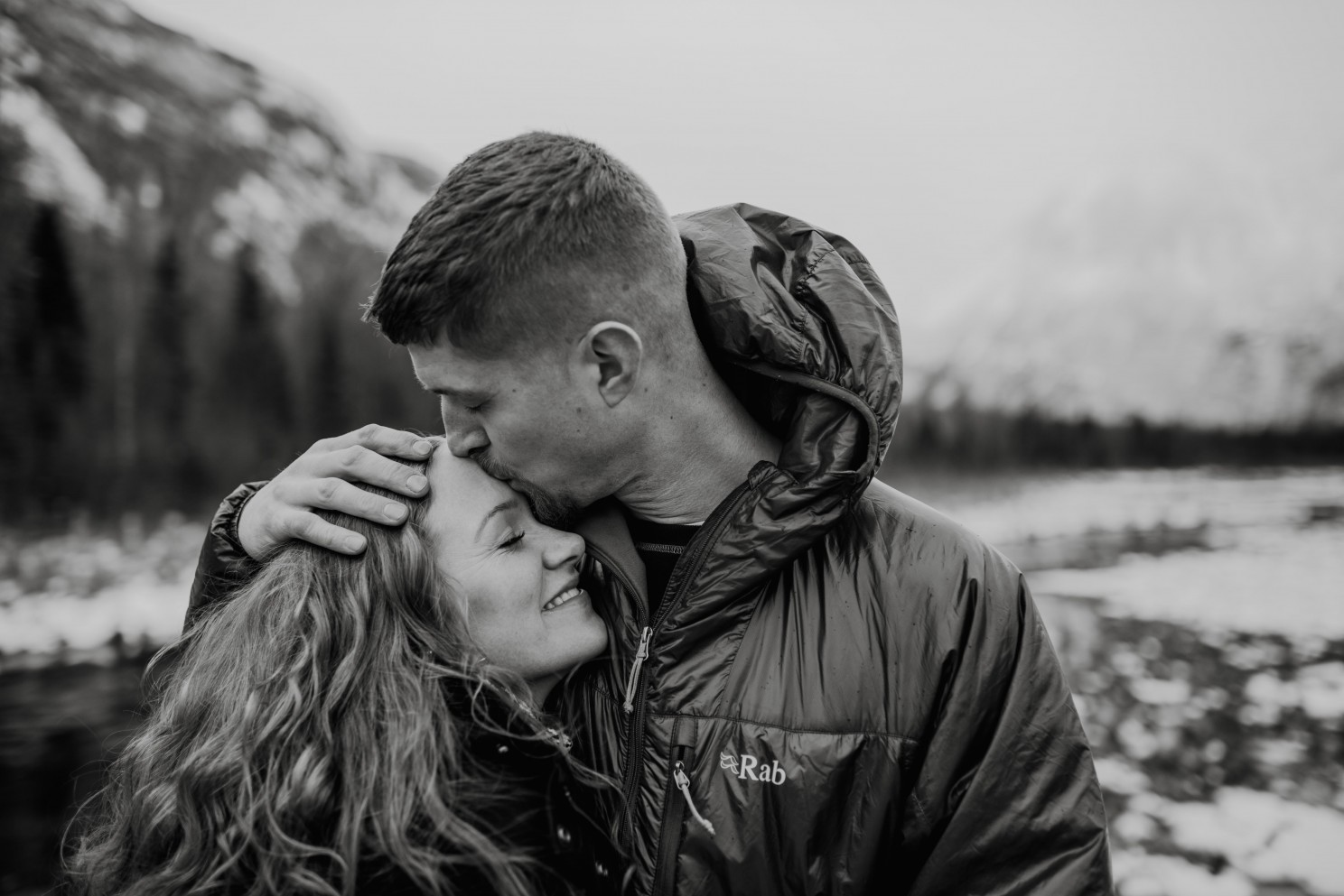 Man kissing wife's forehead